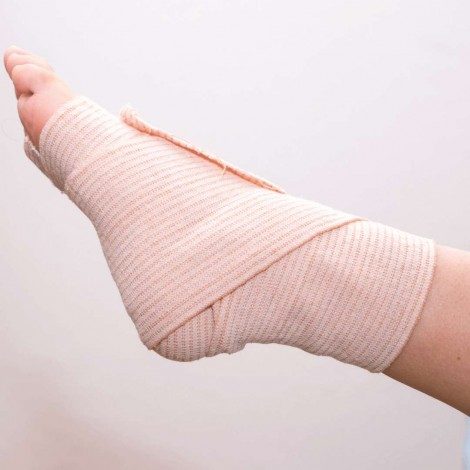 The side of a bandaged foot held in the air