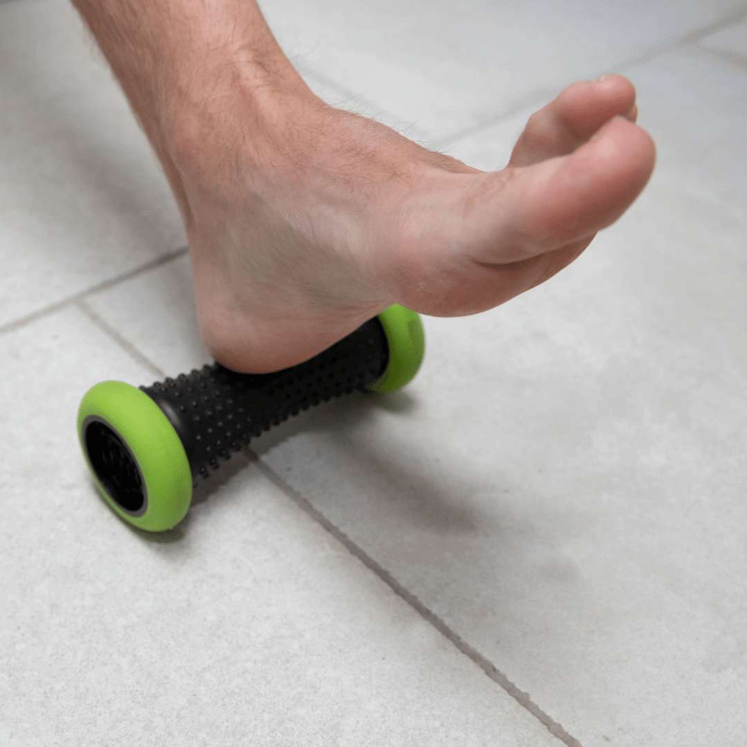Self massage for plantar fasciitis A man using a trigger point roller to massage the bottom of his foot